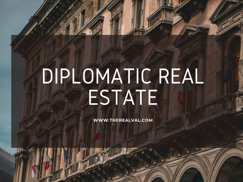 Historic building facade with Diplomatic Real Estate text overlay, promoting www.therealval.com real estate services.