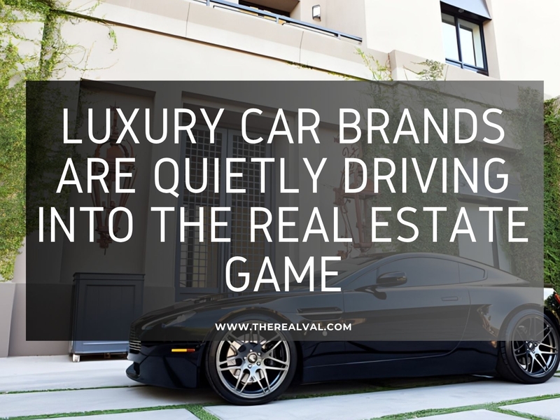 Luxury car parked by modern building, highlighting car brands entering real estate market.