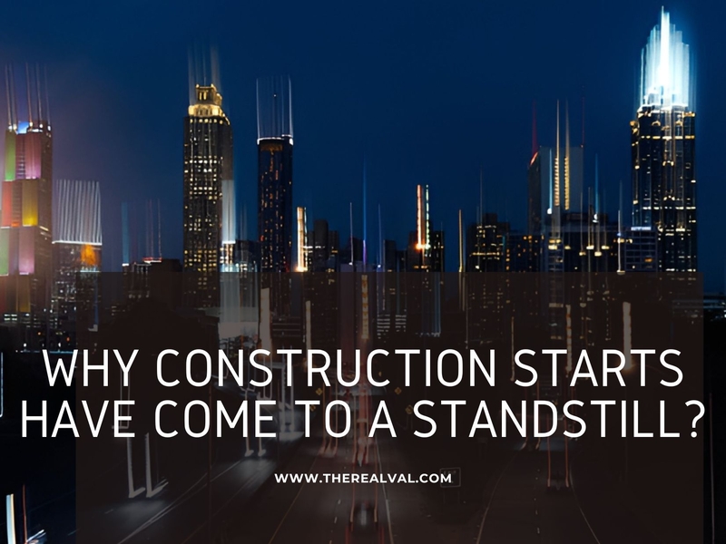 City skyline at night with blurred lights and text: Why Construction Starts Have Come to a Standstill?